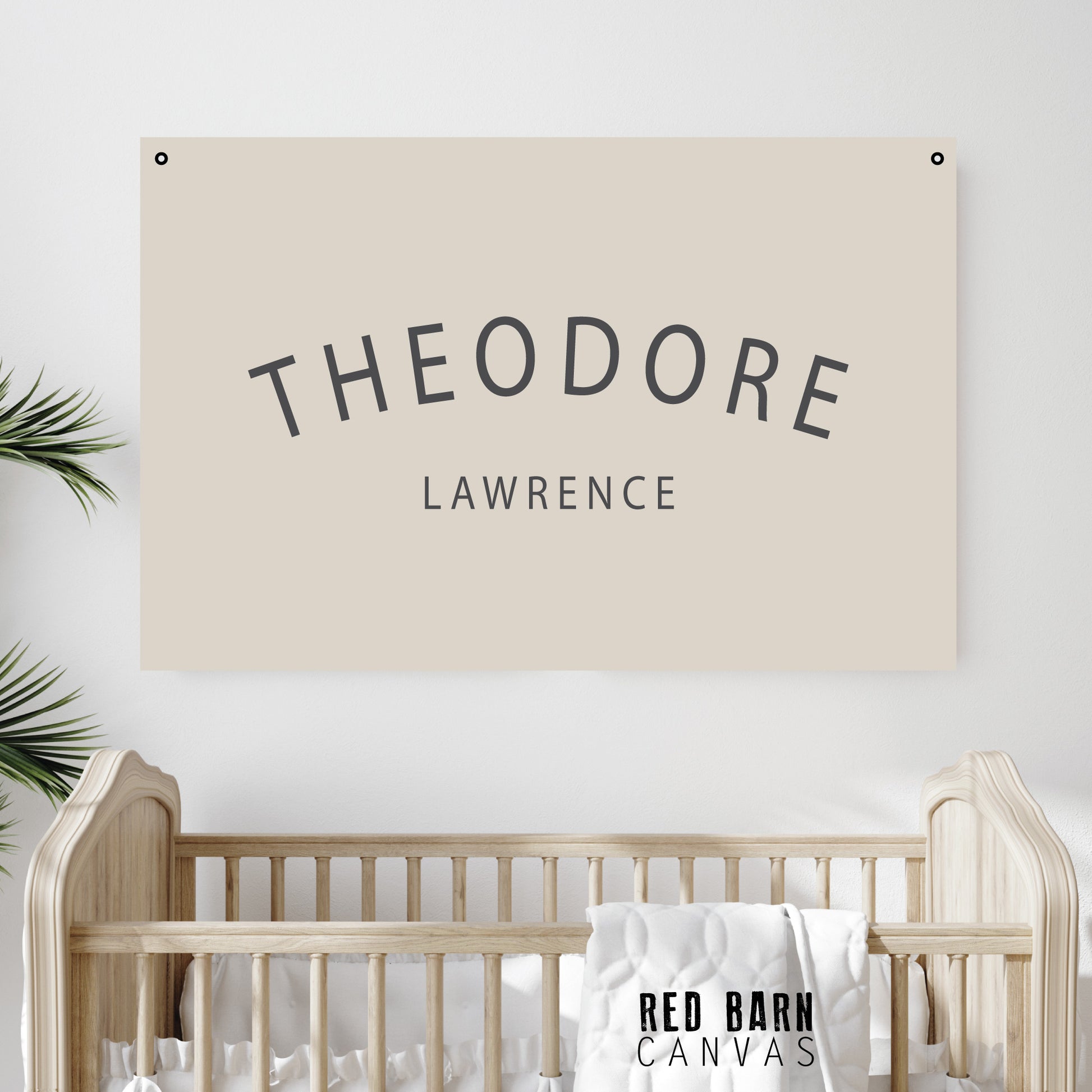 “Baby nursery setup with personalized name tapestry hanging above a wooden crib and soft bedding.”